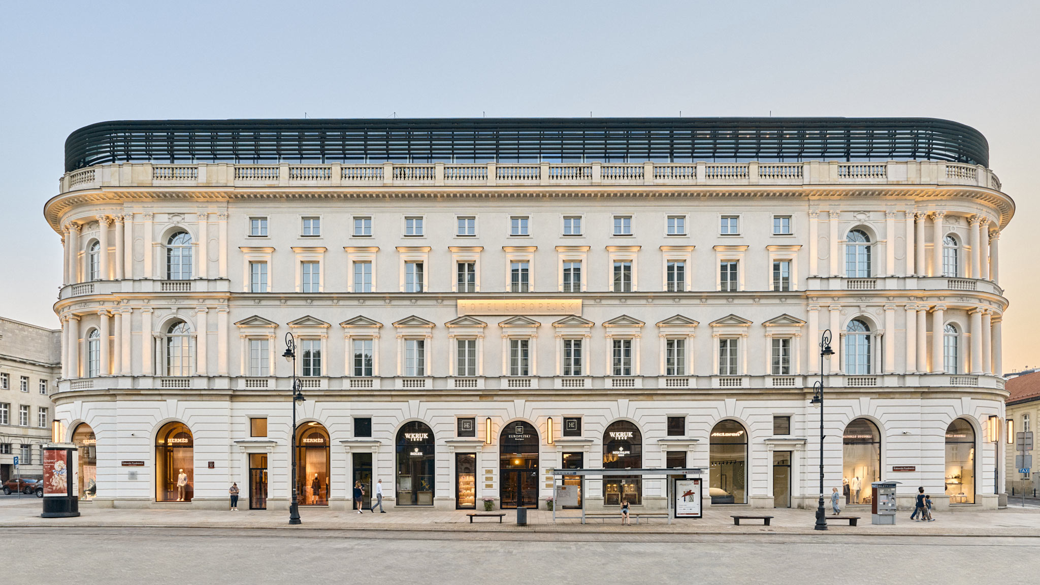 A long classical facade along a wide city avenue.