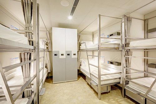 Fitted sleeping units set in bays along a corridor.